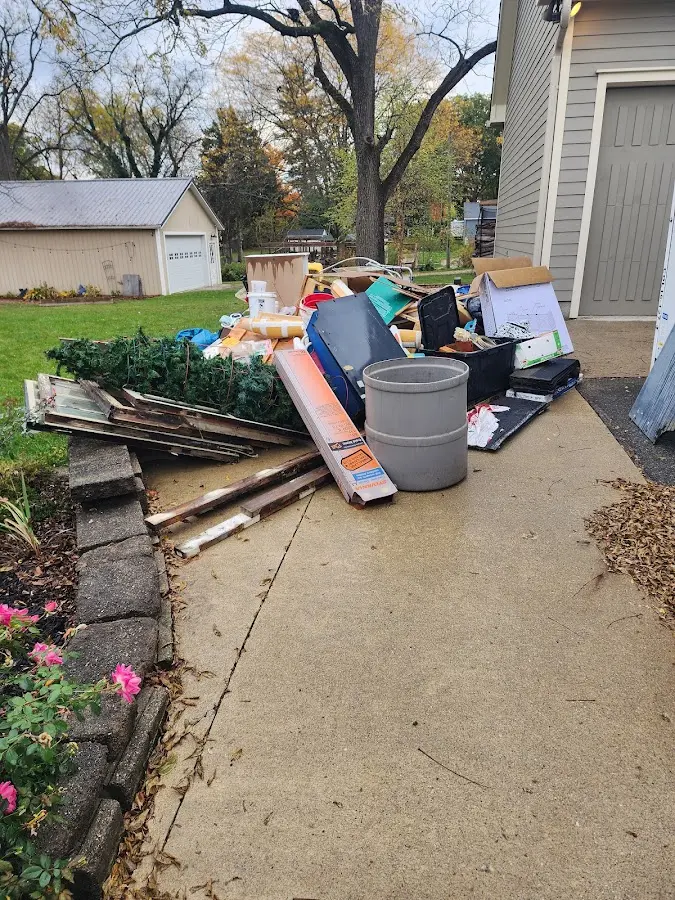Dumpster being loaded with debris for Residential Dumpster Rental in Peculiar